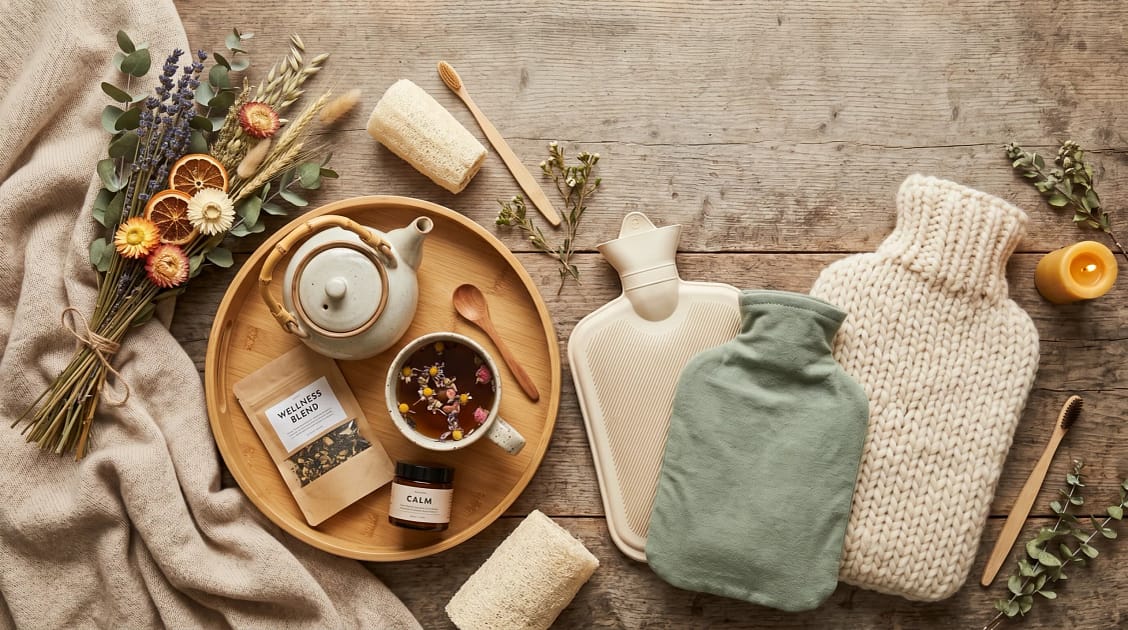 Collection of eco hot water bottles in different sustainable fabrics including organic cotton and wool knit.