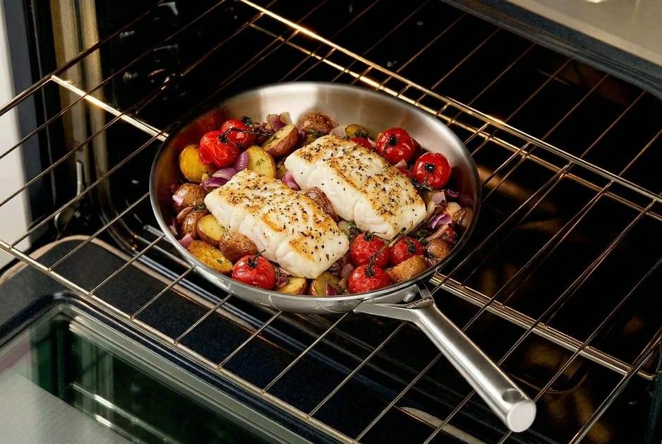 Ninja 30cm frypan on oven shelf with baked salmon and tomatoes.