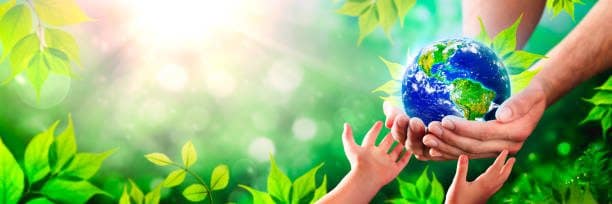Childs hand touching an Adults Hand that is holding an earth globe in their palm