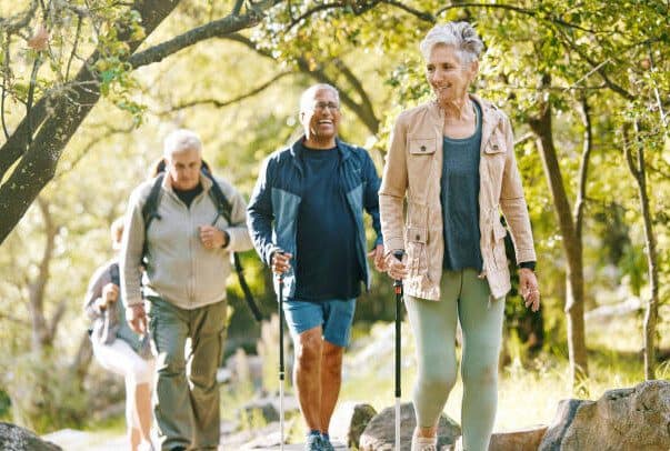 Group of older people walking in natural environment